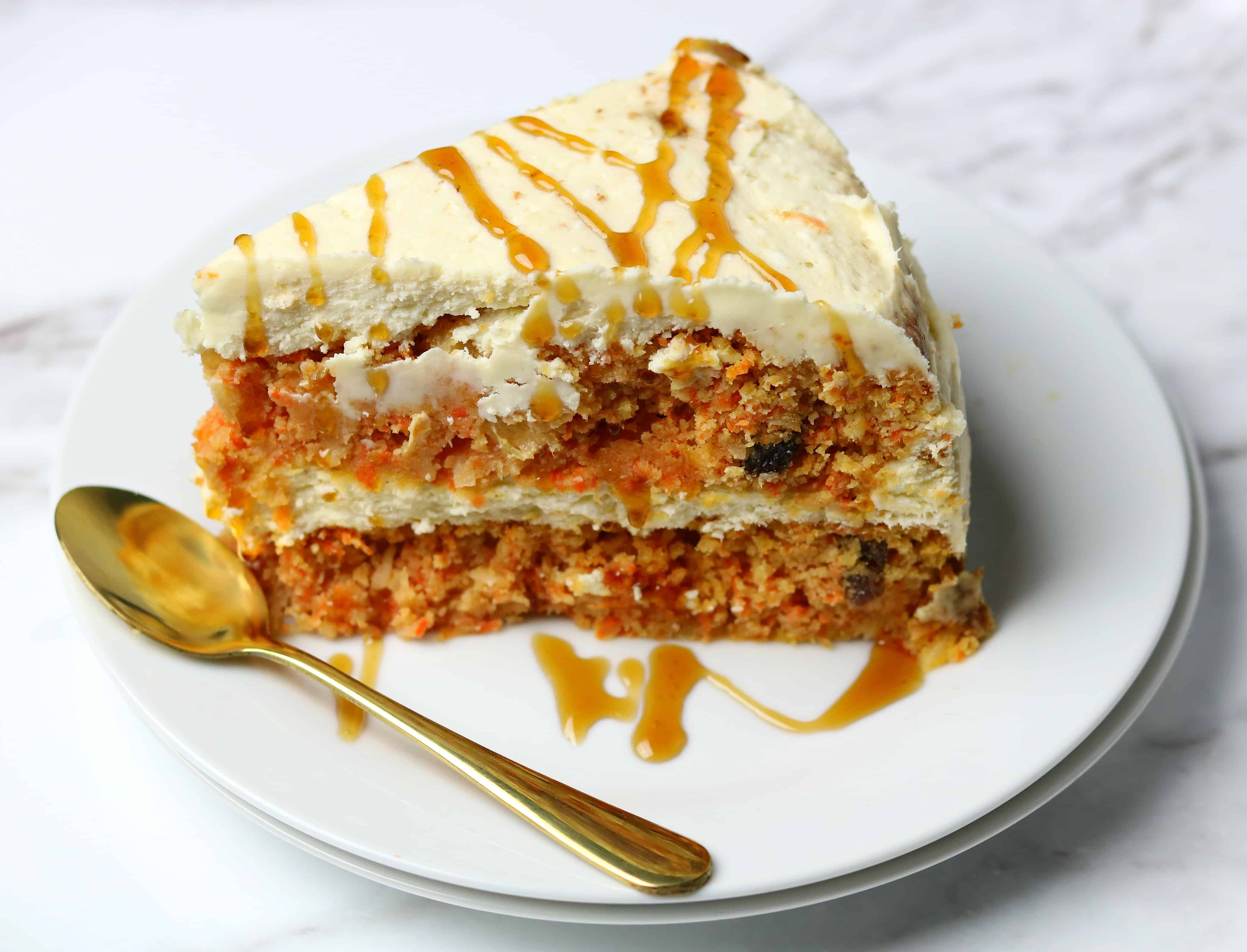 Low-Carb Carrot Cake with a golden spoon on a white plate 