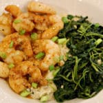 Sweet & Spicy Shrimp with Cheese Cauliflower Grits and Garlic Kale in a white bowl