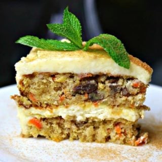 Double layer Low Carb Carrot Cake on a white plate with a mint leaf on top