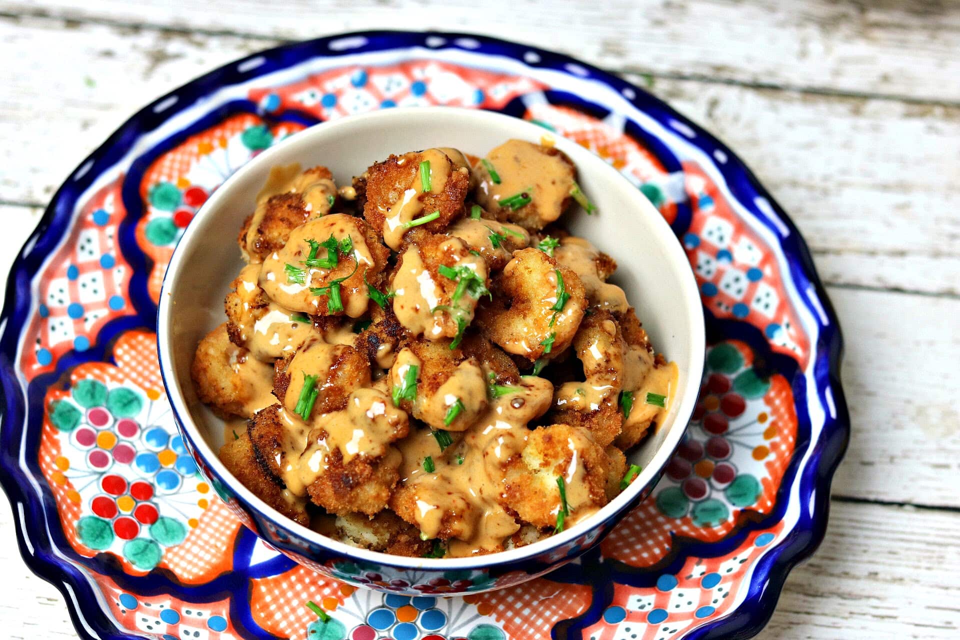 Keto Bang Bang Shrimp in a bowl on a plate