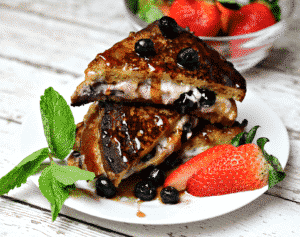 Low-Carb Stuffed French Toast with berries on a white plate 