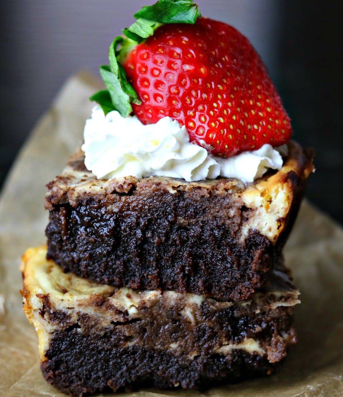 Keto Cheesecake Brownies stacked on top of each other