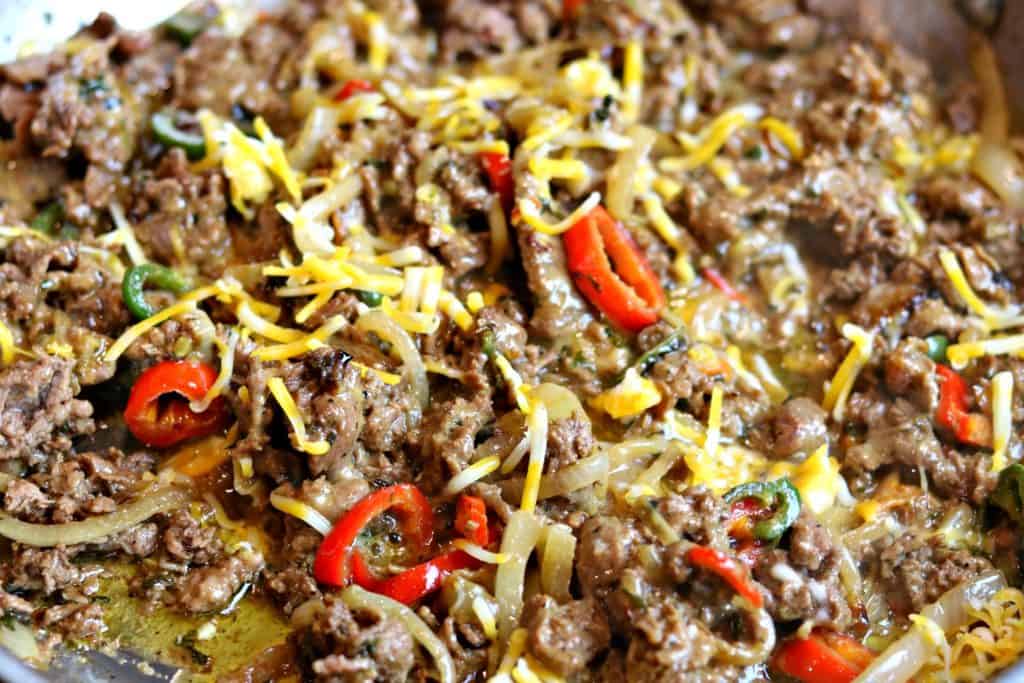 A close up of Philly Cheesesteak with roasted bell peppers.