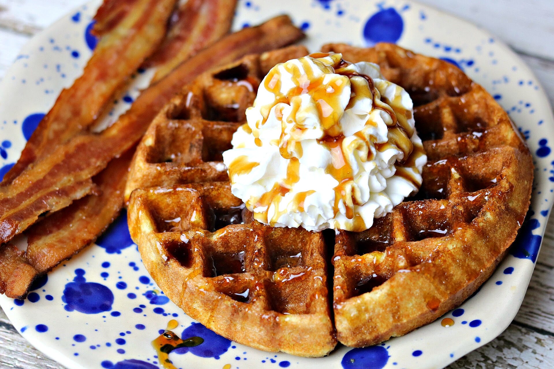 low-carb almond flour keto waffles on a plate with a side of bacon