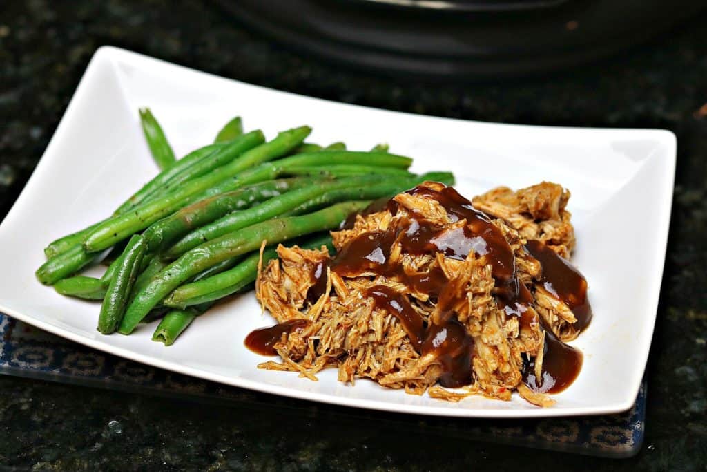Pressure Cooker Keto BBQ Pulled Pork on a plate with green beans