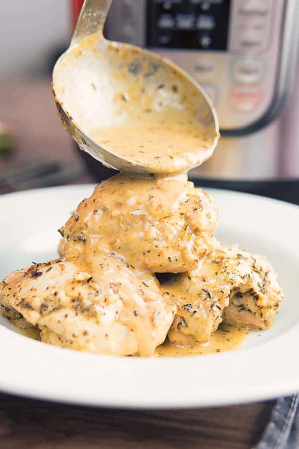 Low Carb Garlic Chicken on a plate with a ladle of sauce