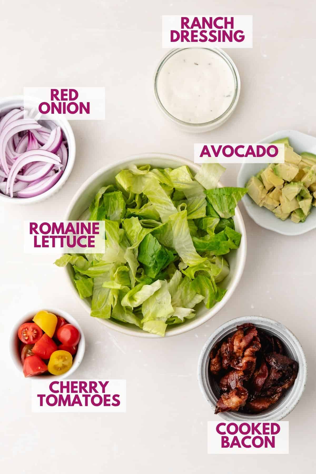 ingredients to make a bacon, lettuce, tomato salad with avocados and ranch dressing in separate bowls