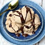 Three scoops of chocolate peanut butter ice cream in a blue bowl