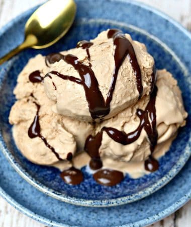 Three scoops of chocolate peanut butter ice cream in a blue bowl