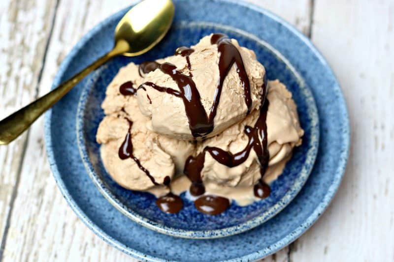 Three scoops of chocolate peanut butter ice cream in a blue bowl