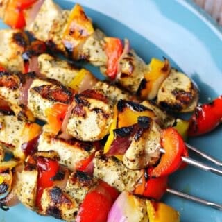 indoor grilled chicken kabobs stacked on a plate
