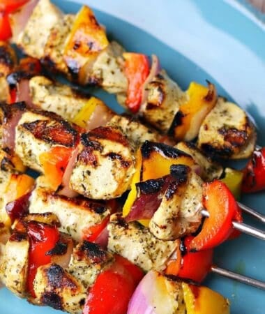 indoor grilled chicken kabobs stacked on a plate