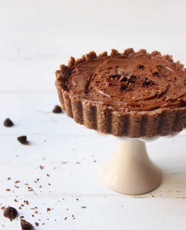 Keto Chocolate Cheesecake on a tiny cheesecake stand 