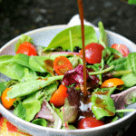 Keto Balsamic Vinaigrette being poured on a salad