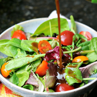 Keto Balsamic Vinaigrette being poured on a salad