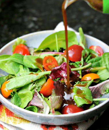 Keto Balsamic Vinaigrette being poured on a salad