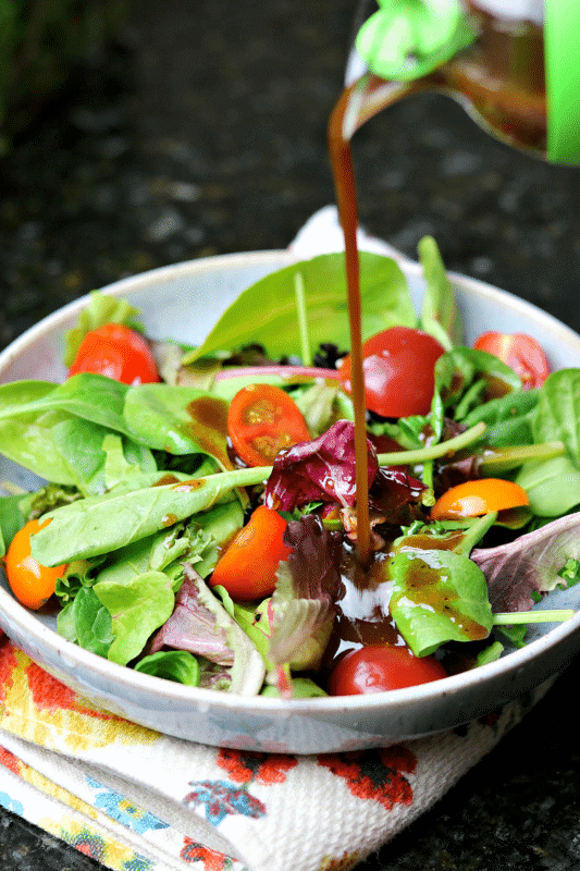 Keto Balsamic Vinaigrette being poured on a salad