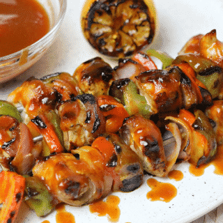 Keto Bacon Wrapped Grilled Chicken Kabobs on a plate