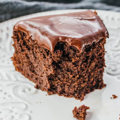 A piece of chocolate cake on a white serving dish