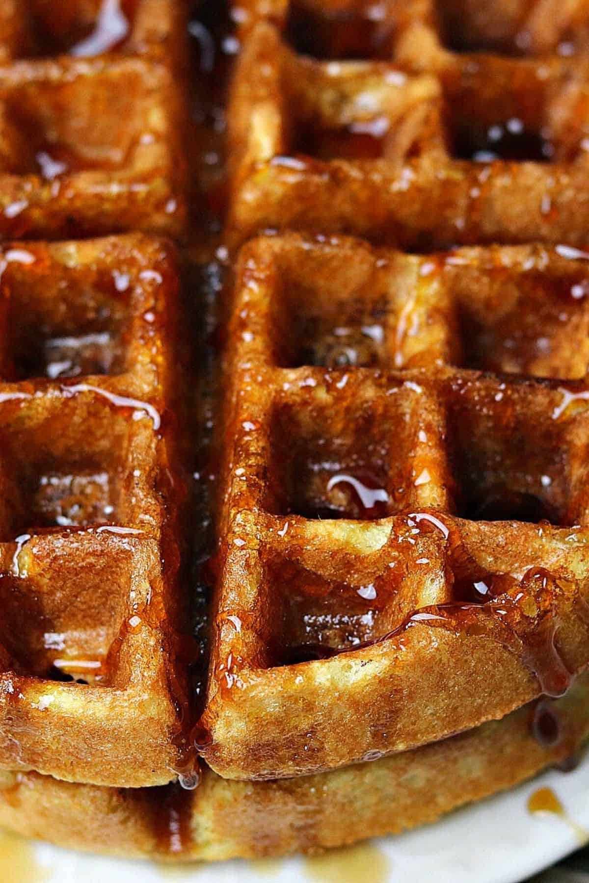 a stack of keto waffles with sugar free syrup