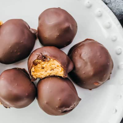 Low-carb candy chocolate peanut butter truffles on a white serving dish
