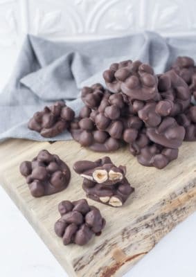 Keto Chocolate nut clusters on a wooden serving dish