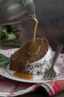 Gingerbread Cream Cheese Pound Cake with sauce being poured on top