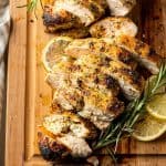 a close up of two sliced chicken breasts on a cutting board