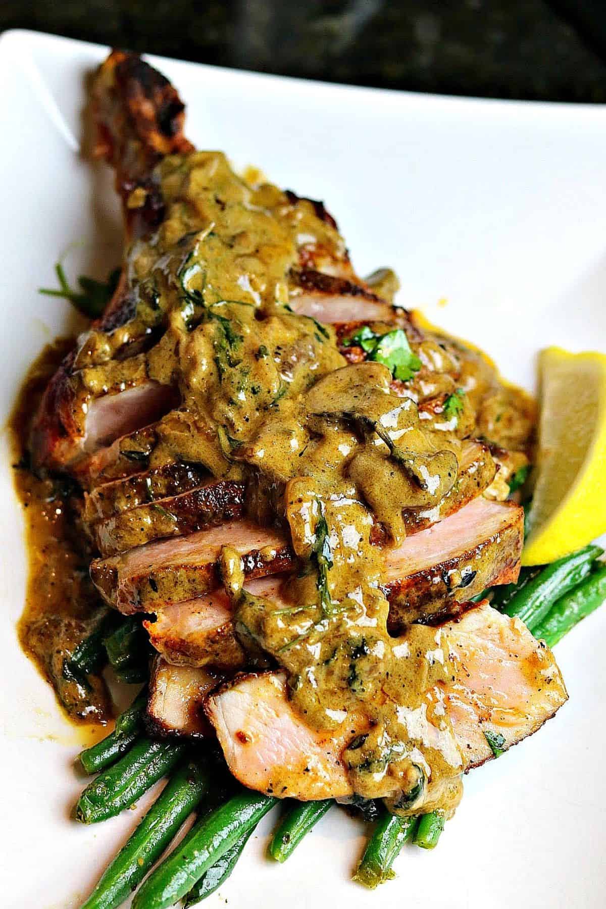sliced cast iron pork chops topped with a creamy pan sauce