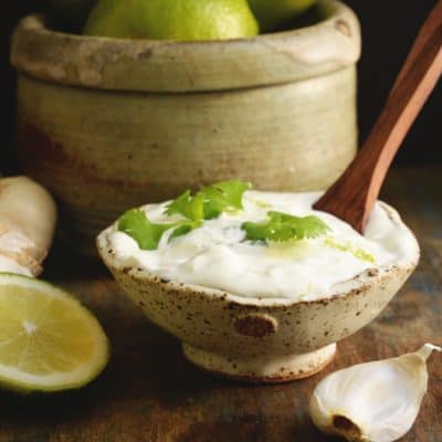 Rustic bowl of Creamy Cilantro Lime Dressing with garnish