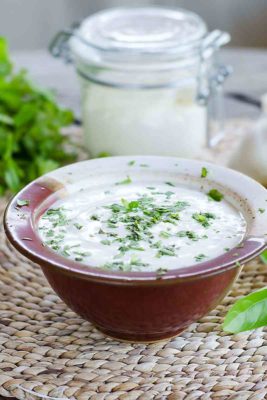 A bowl and jar of Paleo Ranch Dressing