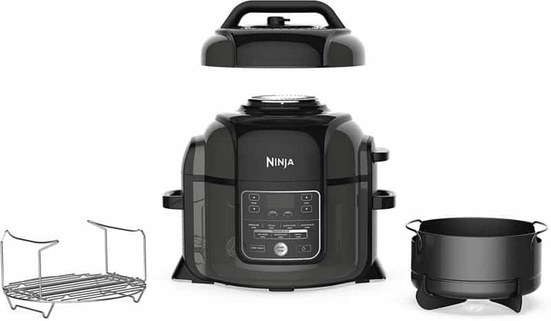 A close up of the Ninja Foodi multi-cooker with two accessories sitting next to it