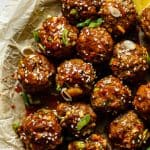 a serving bowl with sticky ginger scallion meatballs