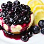 Lemon Blueberry Cheesecake Bites on a white plate with lemon slices