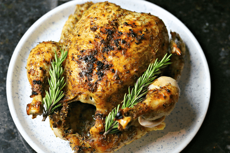Finished Whole Chicken on a plate with rosemary