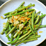 Sauteed Green Beans on a plate with shallots and garlic
