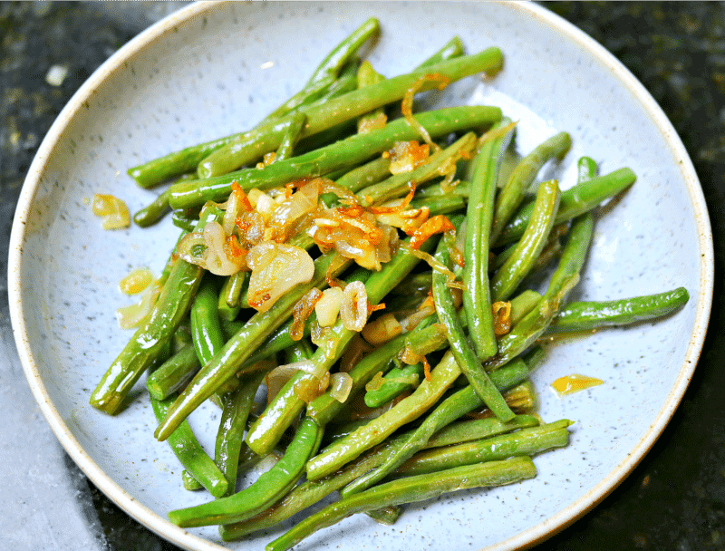 Sauteed Green Beans on a plate with shallots and garlic