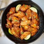 chili lime instant pot wings in a cast iron pan
