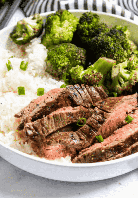 Marinated Sheet Pan Steak and Broccoli in a white serving dish 