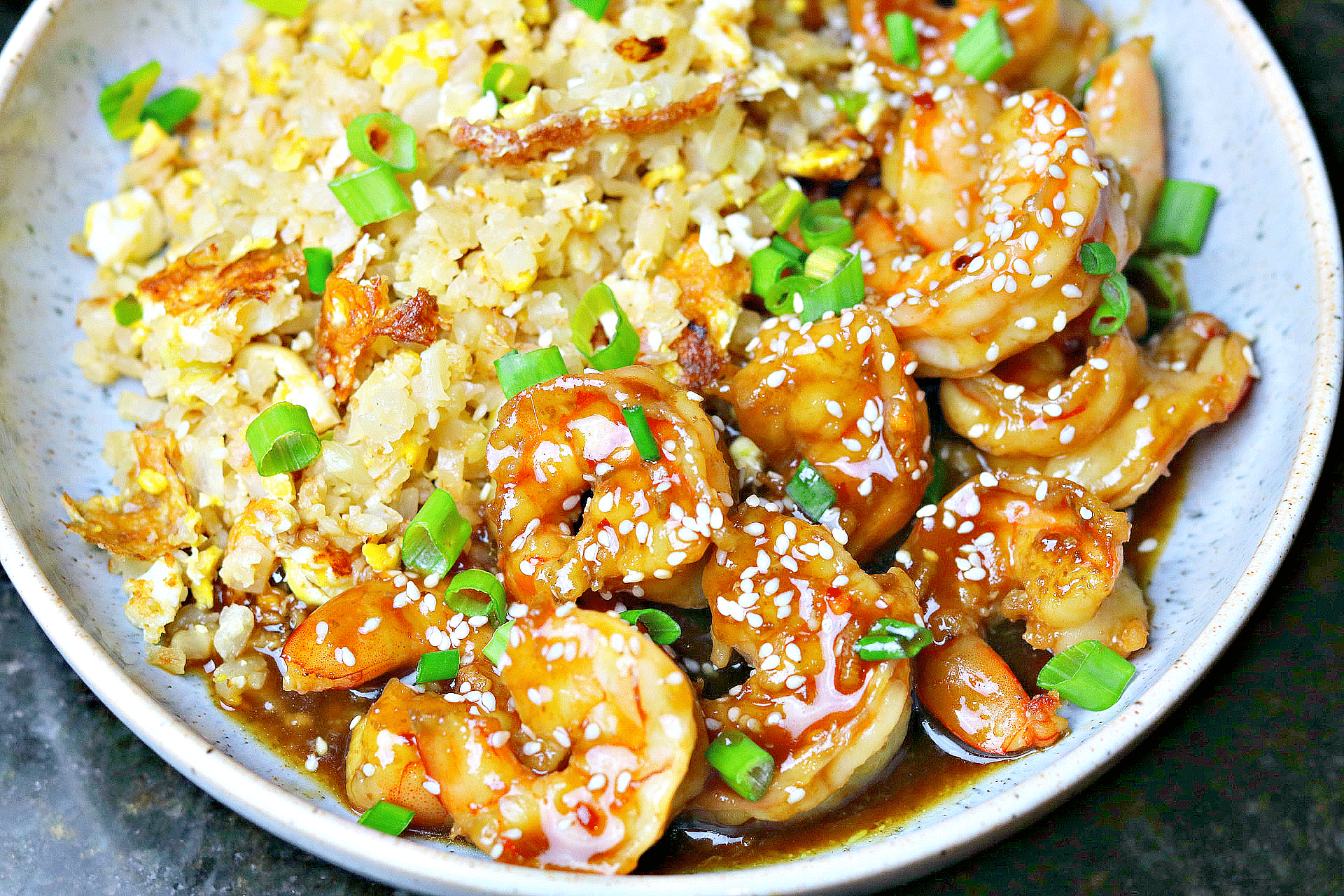 keto orange shrimp in a bowl with cauliflower rice