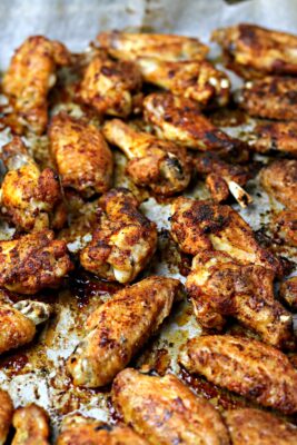 Crispy Baked Wings on a parchment lined baking sheet