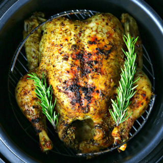 a close-up of the Crock-pot Express with a cooked whole chicken inside it