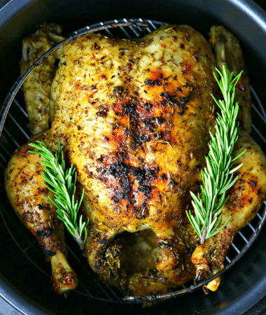 a close-up of the Crock-pot Express with a cooked whole chicken inside it