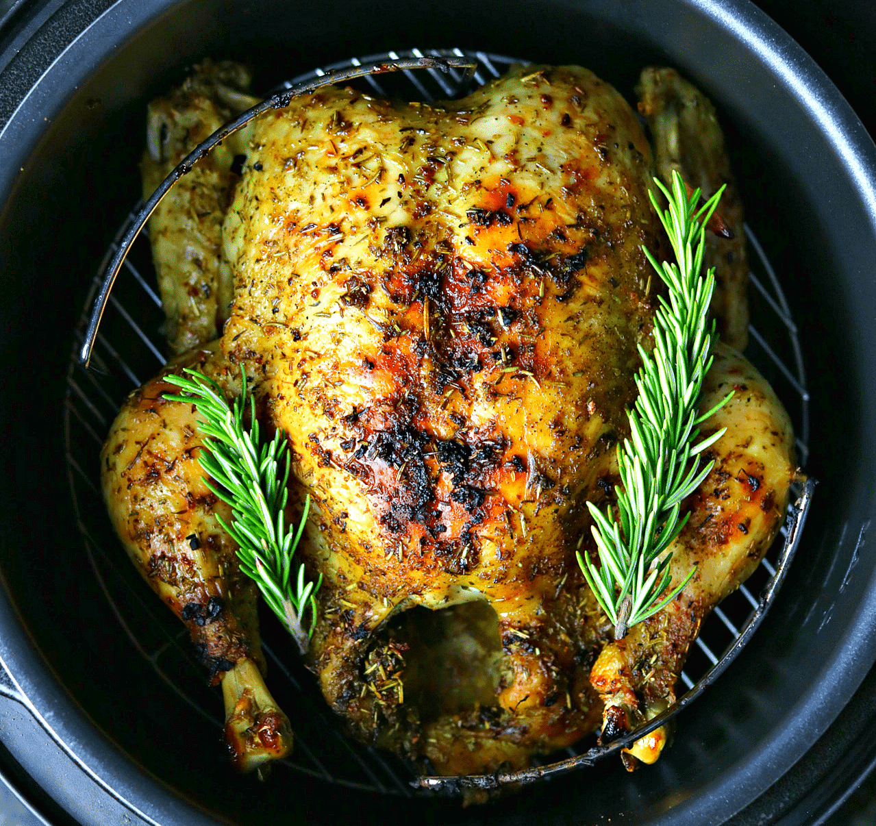 a close-up of the Crock-pot Express with a cooked whole chicken inside it