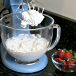 Keto Whipped Cream in a mixer bowl with berries