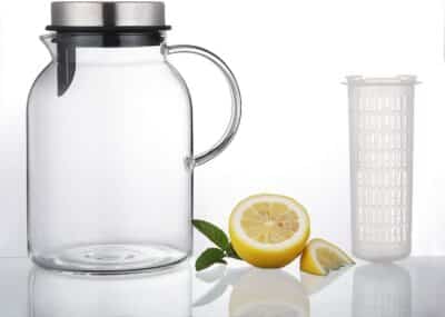 The Hiware Water Pitcher on a table next to half a lemon.