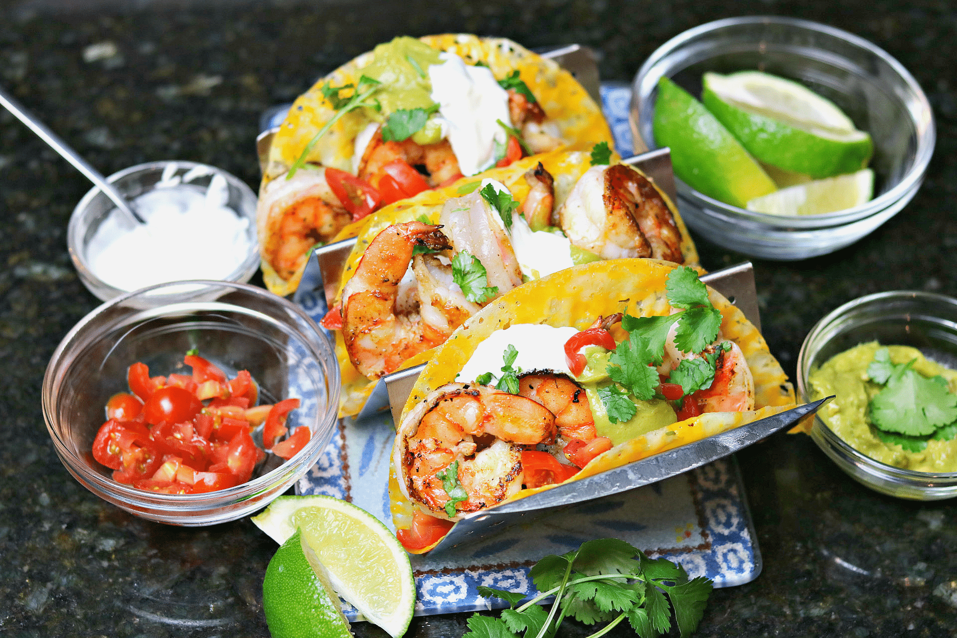 three shrimp tacos on a taco stand