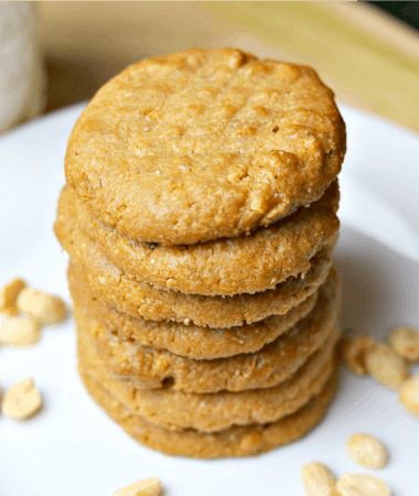 keto peanut butter cookies stacked on a white plate