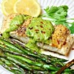 pan seared halibut recipe on a plate with a form and chimichurri sauce