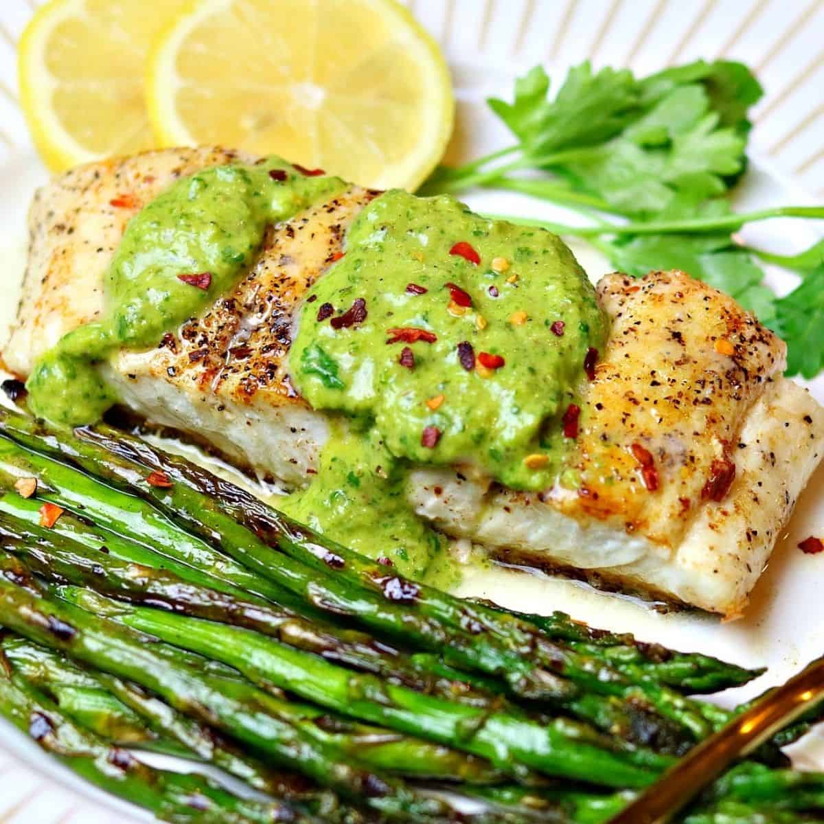 pan seared halibut recipe on a plate with a form and chimichurri sauce